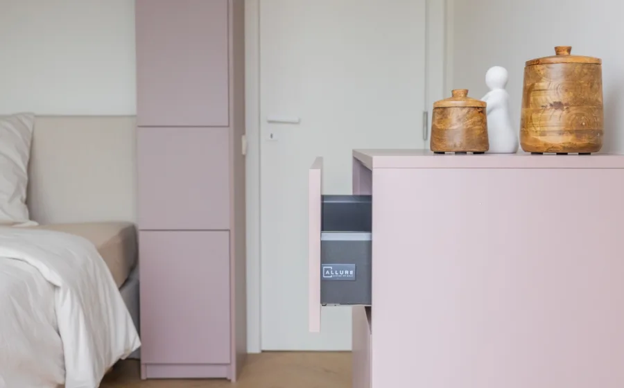 Detail slaapkamer kast op maat in lichte pasteltint met praktische lades