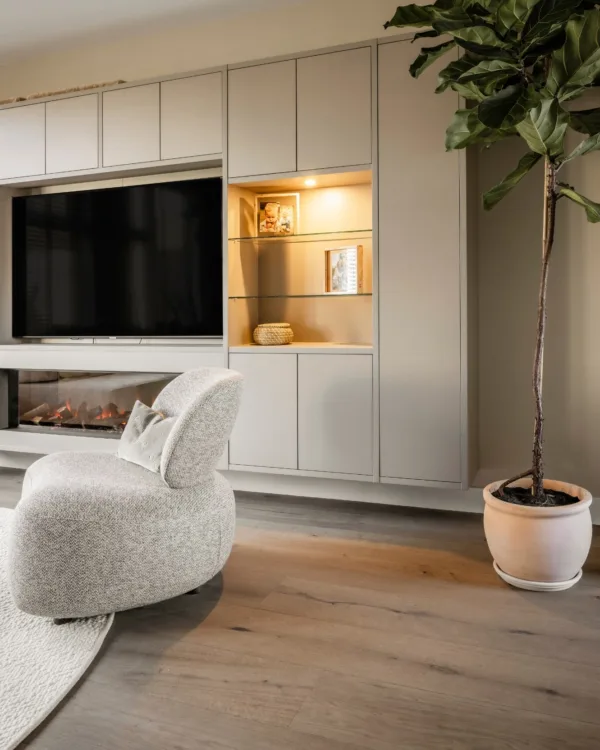 Kast op maat in de kleur U115 Nature Grey in de living. Met geïntegreerde verlichting.