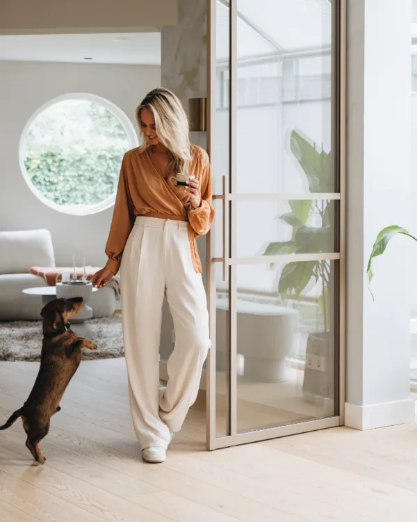 Beige stalen pui in de woonkamer met een houten Lindura vloer